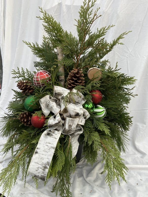 Planter A 8" Bow with accents and cones.